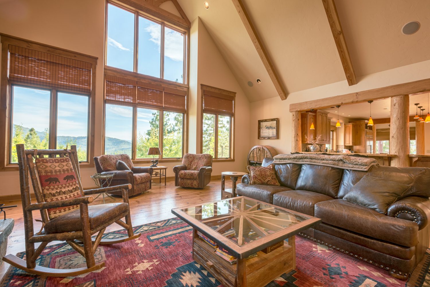 Mountain Top Getaway great room with timber posts and tall windows