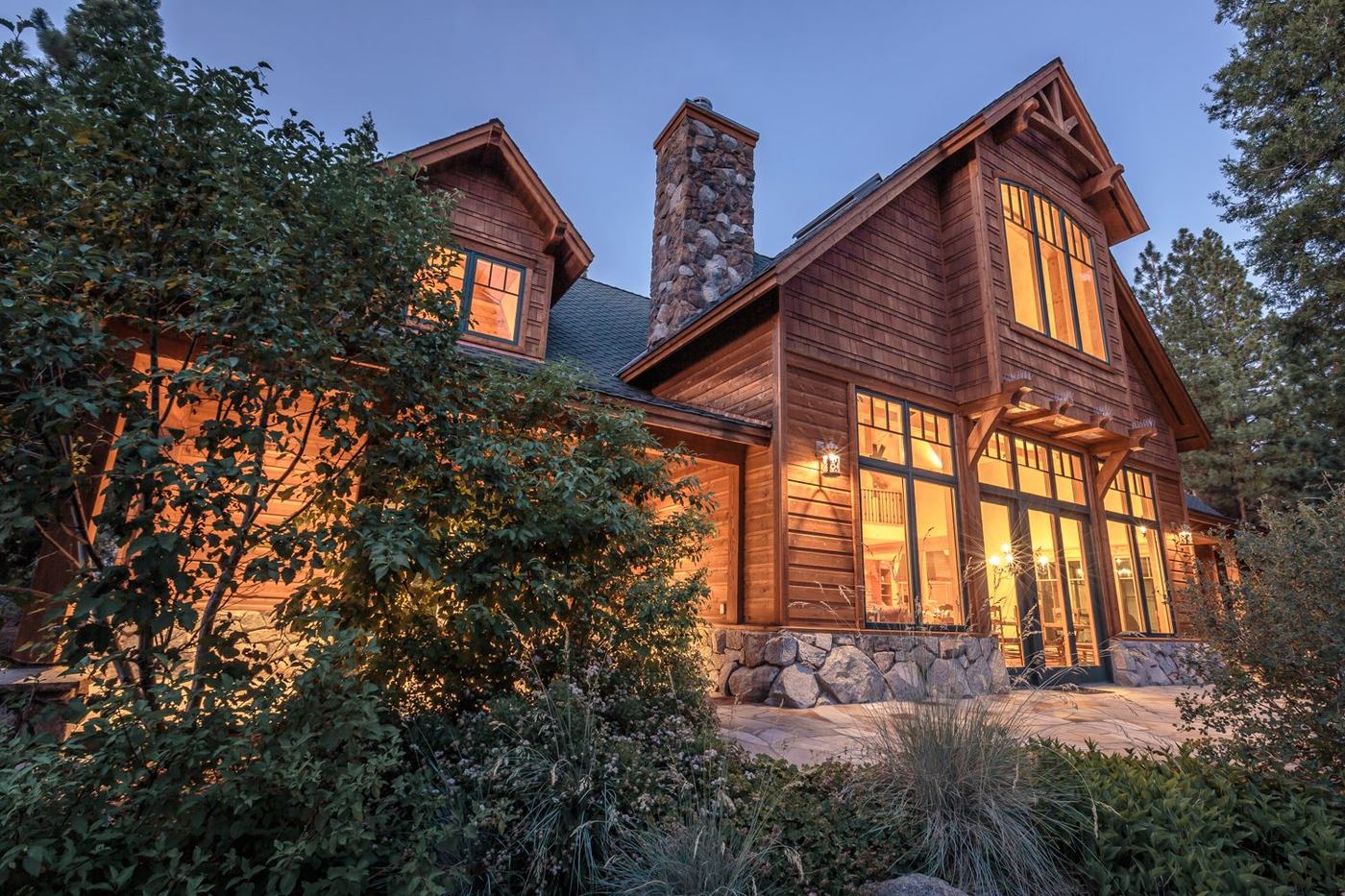 Peppergrass Lane Mountain Escape at dusk, timber gables and stone chimney lit from within