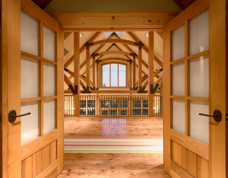 Timber-framed doorway into the great room